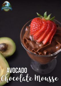 A glass of avocado chocolate mousse topped with a sliced strawberry, with text Avocado Chocolate Mousse