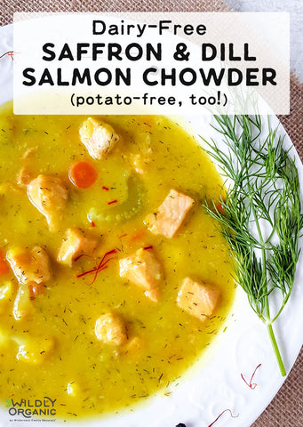 Bowl of dairy-free saffron and dill salmon chowder with a sprig of dill