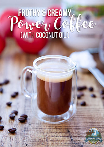 A glass mug of frothy coffee with a cream layer on top, surrounded by coffee beans, with text overlay
