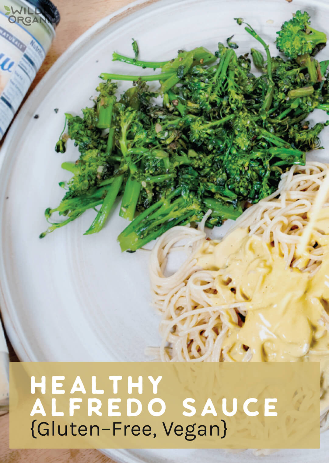 Picture of a white plate with pasta alfredo and broccoli.