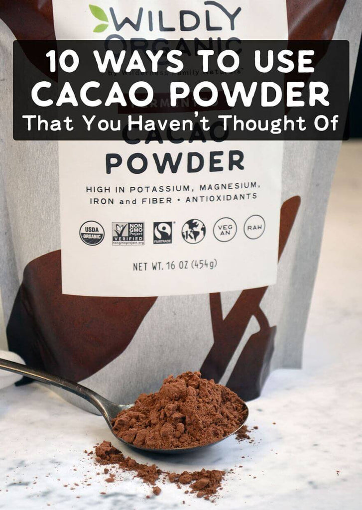Brown powder on a spoon in front of a bag of cacao powder