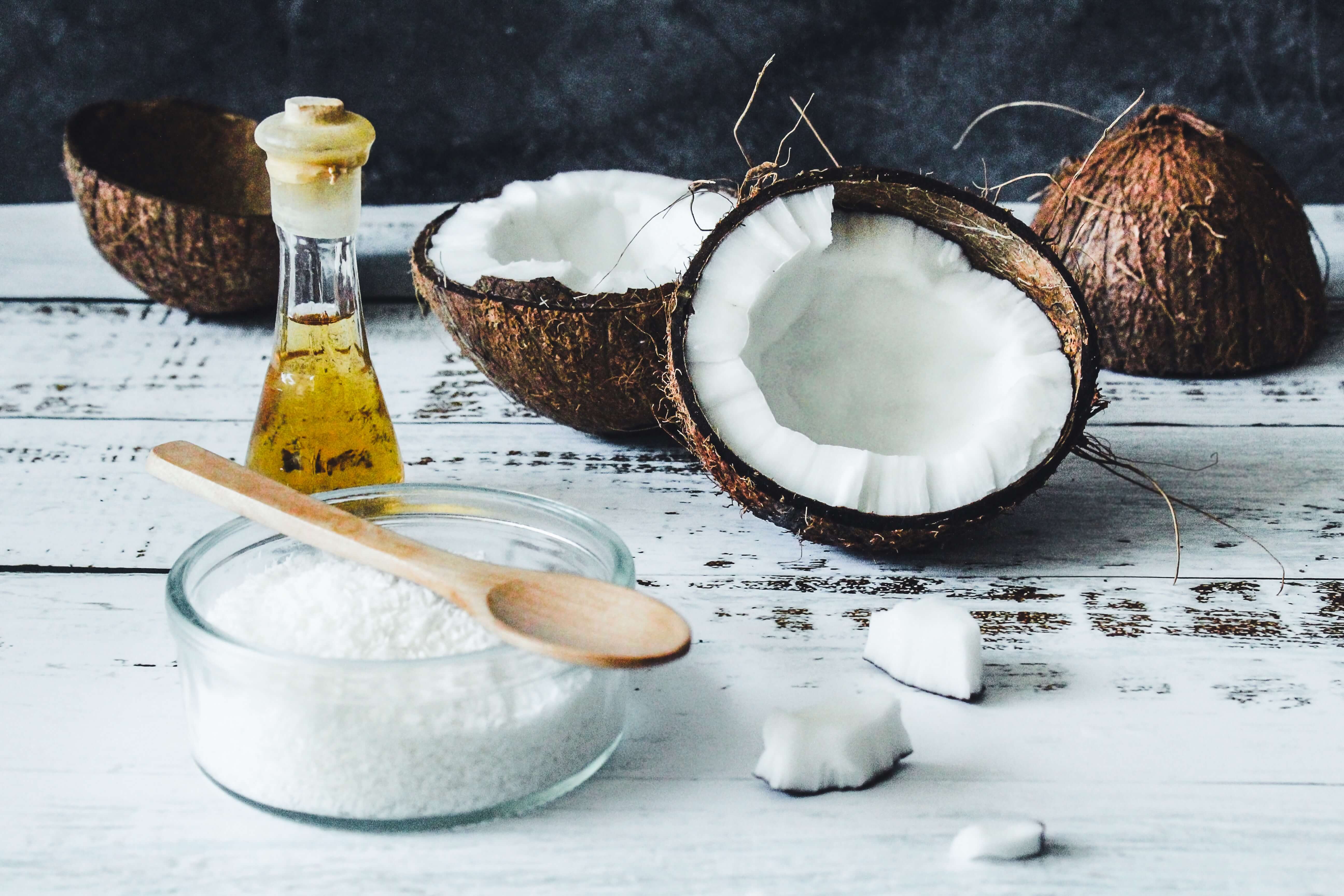 Raw broken coconuts, coconut flakes, and coconut oil