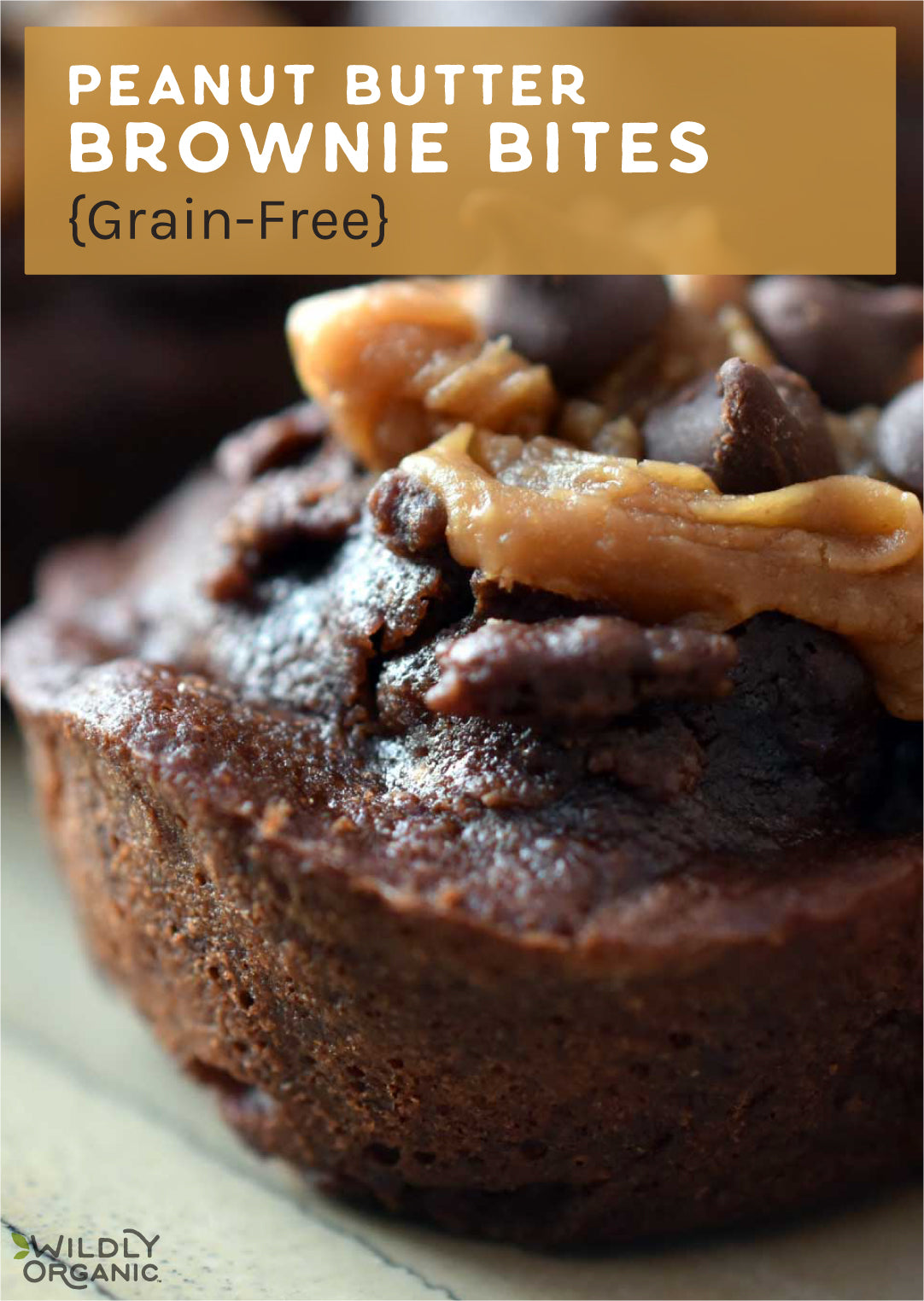 Close-up of a peanut butter brownie bite with a dollop of peanut butter on top, labeled as grain-free