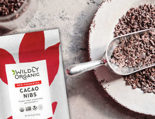 Raw cacao nibs beside package