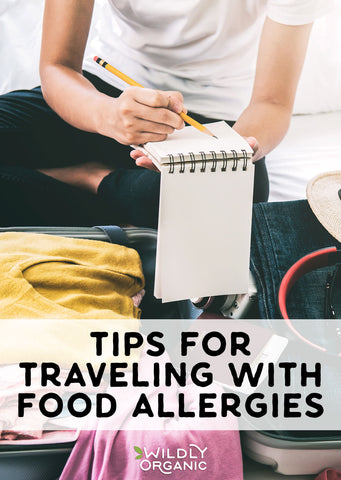 photo of someone checking off their packing list with their suitcase in front of them.