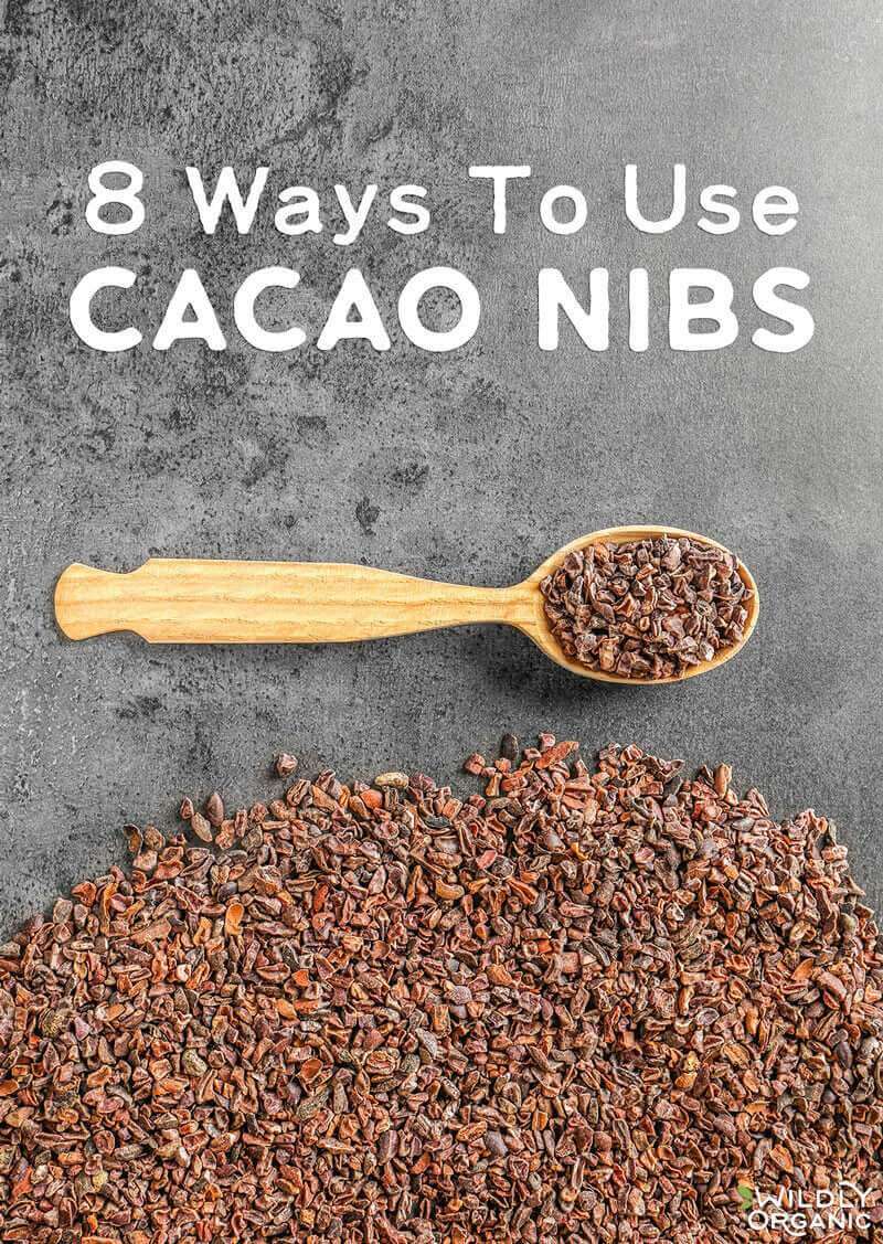 8 Ways To Use CACAO NIBS above a spoonful of cacao nibs on a dark surface.