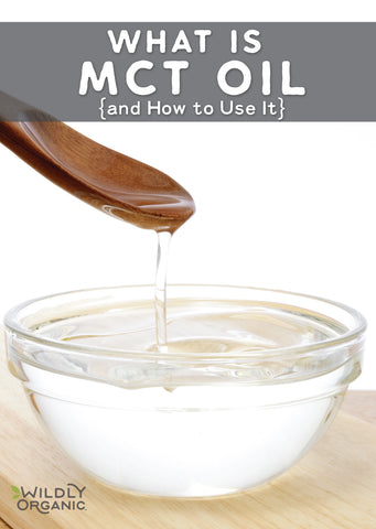 A clear glass bowl of MCT oil and a wooden spoon.