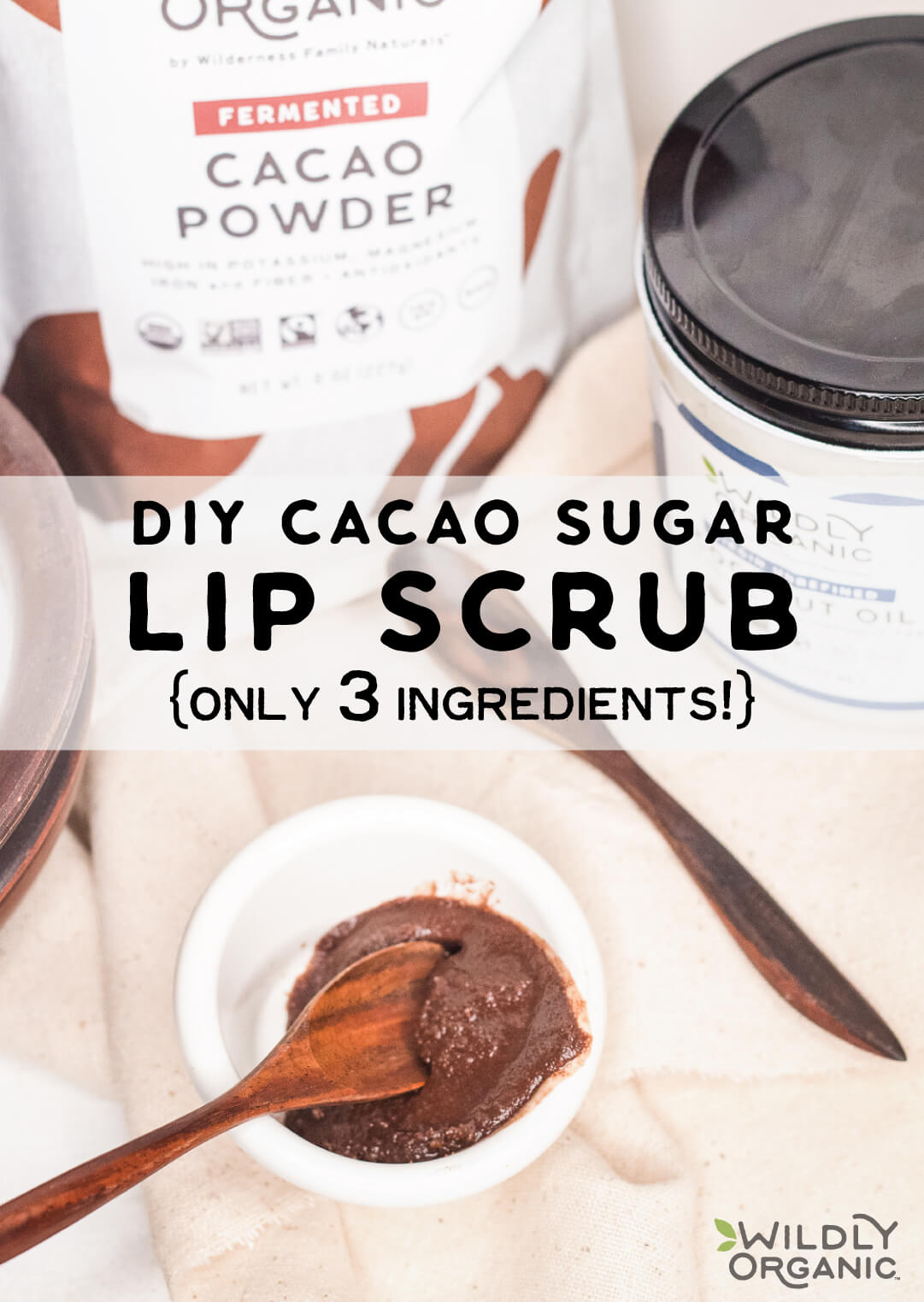 Homemade cacao sugar lip scrub in a small bowl with a spoon, and ingredients displayed in the background