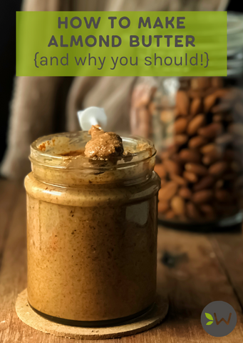 Jar of almond butter with a spoon and almonds in background, with text about making almond butter